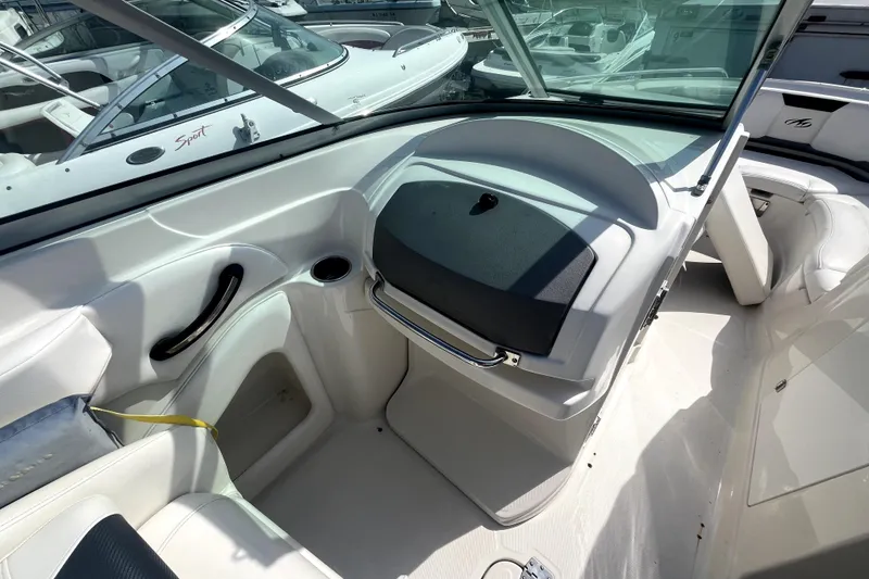 Slide: The Image of 2011 Monterey 254FSC boat interior with white seating and dashboard view. - 24