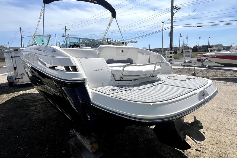 Slide: The Image of 2011 Monterey 254FSC boat with sleek design, docked outdoors under clear sky. - 3
