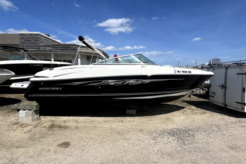 Slide: The Image of 2011 Monterey 254FSC boat on display outdoors under a clear blue sky. - 6