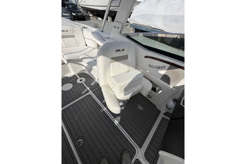 Slide: The Image of Interior of a 2008 Sea Ray SLX 250 boat with white seating and sleek design. - 2