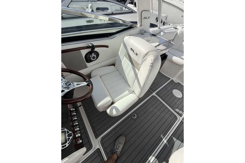 Slide: The Image of 2008 Sea Ray SLX 250 boat interior with white seating and sleek steering wheel design. - 3