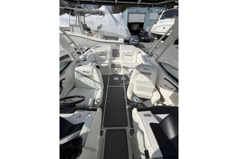 Slide: The Image of 2008 Sea Ray SLX 250 boat interior with white seating and sleek design. - 4