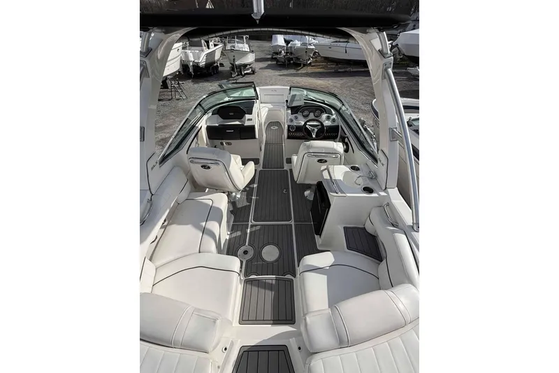Slide: The Image of 2008 Sea Ray SLX 250 boat interior with white seating and modern dashboard. - 6