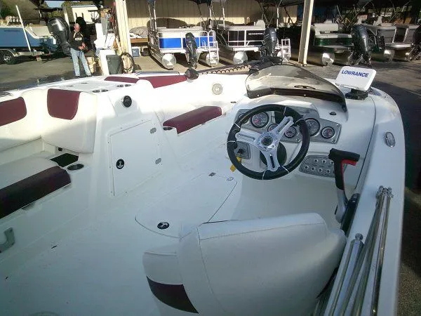 Slide: The Image of Interior of a 2019 Tahoe 1950 Deck boat with steering console. - 5
