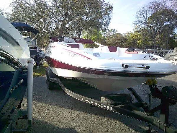 Slide: The Image of 2019 Tahoe 1950 Deck boat parked outdoors on trailer. - 7