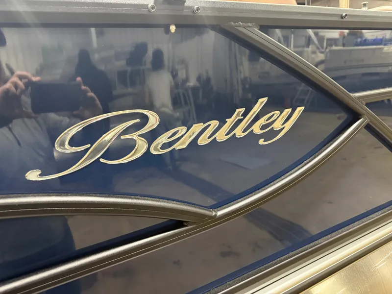 Slide: The Image of Bentley Pontoons Legacy 223 Tritoon, blue design, close-up of logo. - 43