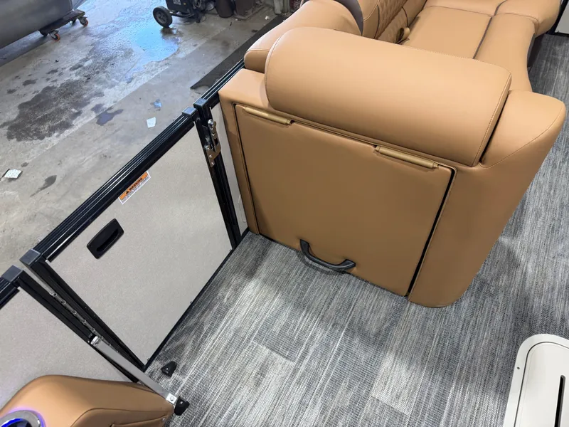 Slide: The Image of Interior of Tahoe Cascade 2385 Tritoon with beige leather and carpet flooring. - 30