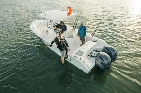 Slide: The Image of 2022 Sea Hunt Gamefish 25 boat with divers and anglers on the water. - 6
