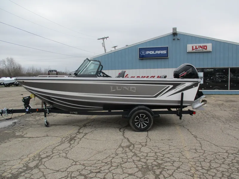 The Image of 2026 Lund 1875 Tyee boat on trailer in front of Polaris building. - 1