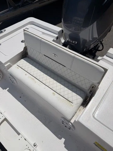 Slide: The Image of Sportsman Masters 207 boat seat, 2022 model, with engine in background. - 7