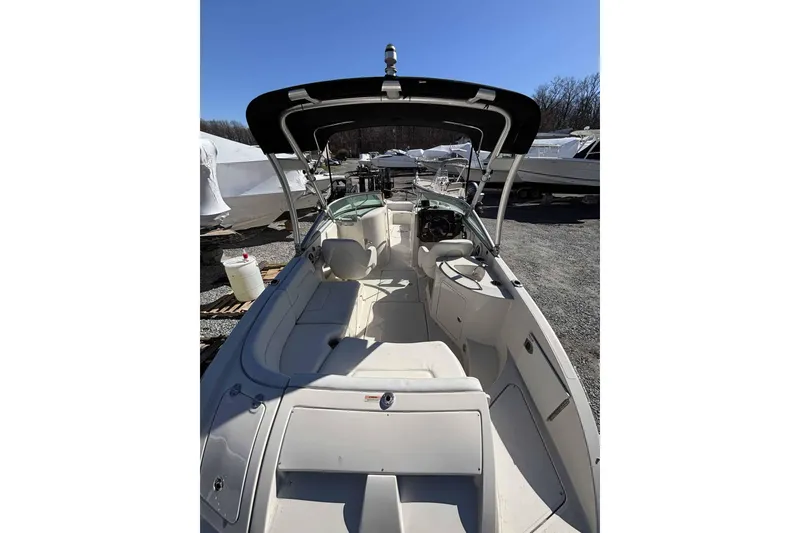 Slide: The Image of 2008 Sea Ray 260 Sundeck boat with spacious seating and canopy, docked outdoors. - 1