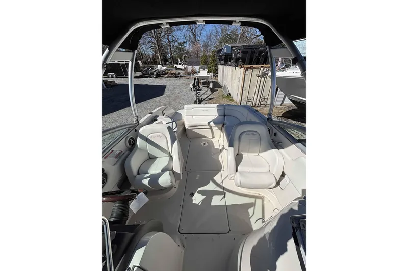 Slide: The Image of 2008 Sea Ray 260 Sundeck interior with white seating and open deck layout. - 2