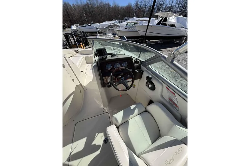 Slide: The Image of 2008 Sea Ray 260 Sundeck boat interior with steering wheel and dashboard controls. - 3