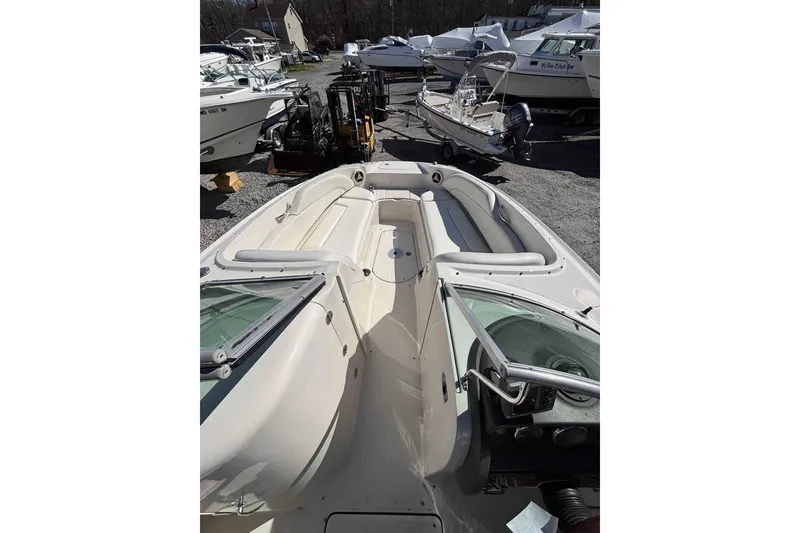 Slide: The Image of 2008 Sea Ray 260 Sundeck boat with spacious seating, parked in a marina. - 4