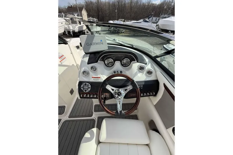 Slide: The Image of 2008 Sea Ray 260 Sundeck dashboard with Garmin navigation system and wood-accented steering wheel. - 5