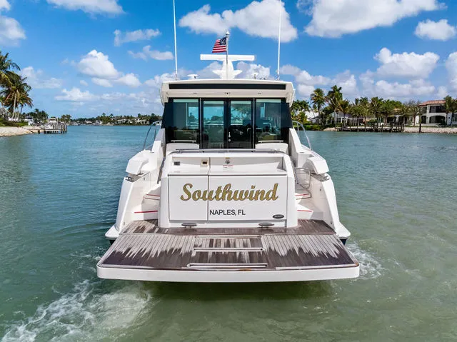 Slide: The Image of 2018 Tiara Yachts C44 cockpit with steering wheel and controls. - 14