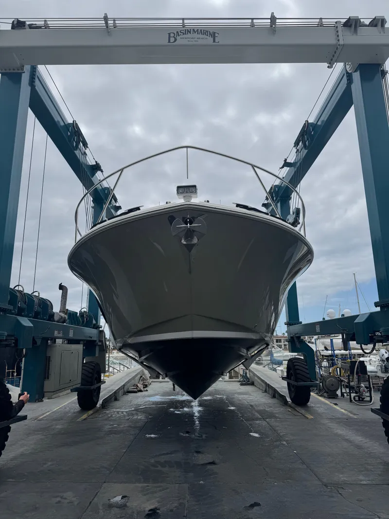 Slide: The Image of 2018 Tiara Yachts C44 on a boat lift at the marina. - 2