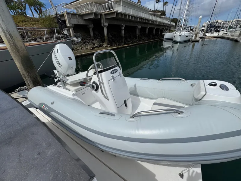 Slide: The Image of 2018 Tiara Yachts C44 with tender at the marina. - 25