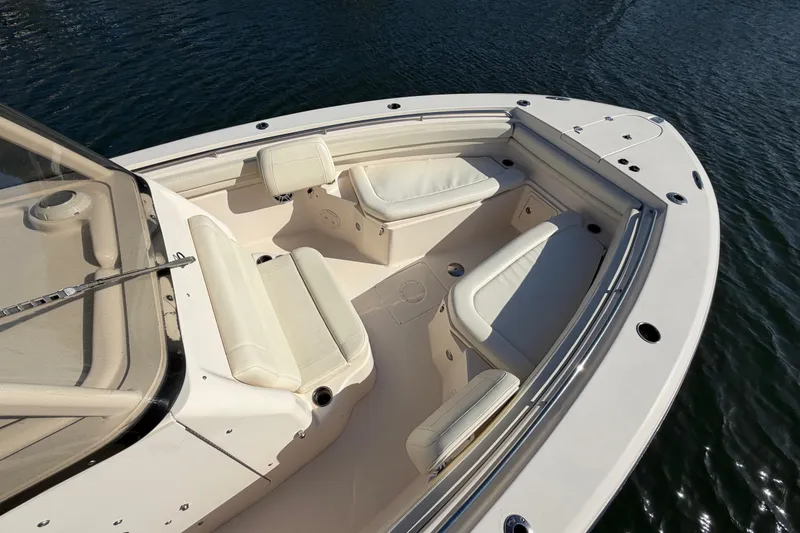 Slide: The Image of 2018 Grady-White Canyon 306 boat interior with cushioned seating on water. - 11