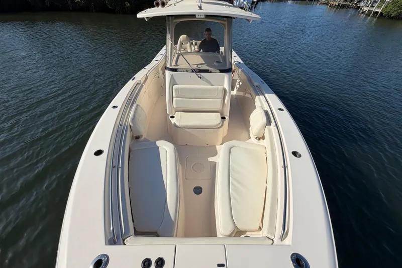 Slide: The Image of 2018 Grady-White Canyon 306 boat on water, featuring spacious seating and sleek design. - 12