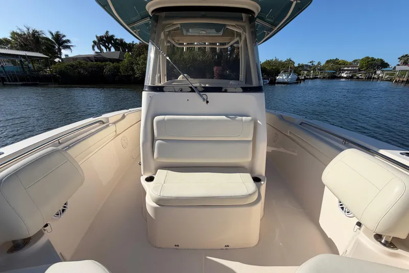Slide: The Image of 2018 Grady-White Canyon 306 boat interior with seating, on a sunny day by the water. - 14
