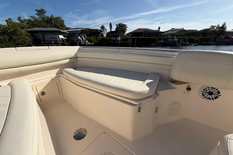 Slide: The Image of 2018 Grady-White Canyon 306 boat interior with cushioned seating and speaker system. - 15