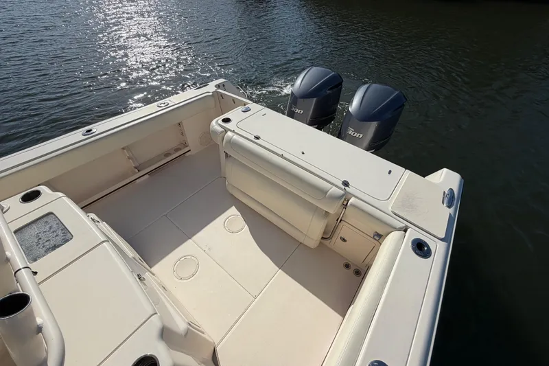 Slide: The Image of 2018 Grady-White Canyon 306 boat deck with twin engines on water. - 16