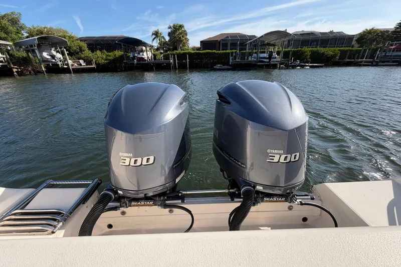 Slide: The Image of Twin Yamaha 300 engines on a 2018 Grady-White Canyon 306 boat by the water. - 17