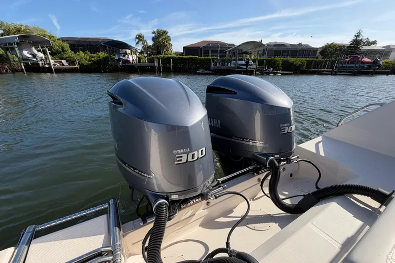 Slide: The Image of 2018 Grady-White Canyon 306 with twin Yamaha 300 engines on a sunny waterfront. - 18