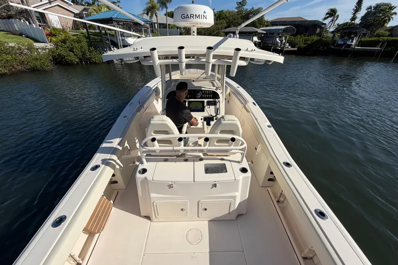 Slide: The Image of 2018 Grady-White Canyon 306 boat on water, featuring Garmin navigation system. - 20