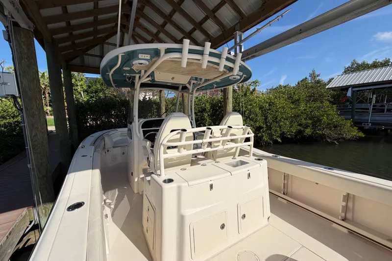 Slide: The Image of 2018 Grady-White Canyon 306 boat docked under a wooden shelter. - 21