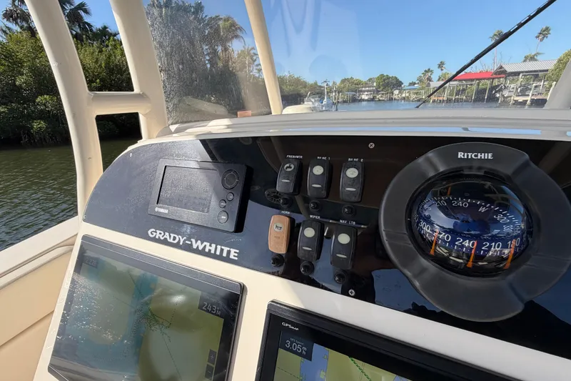 Slide: The Image of 2018 Grady-White Canyon 306 boat dashboard with navigation instruments and compass. - 29