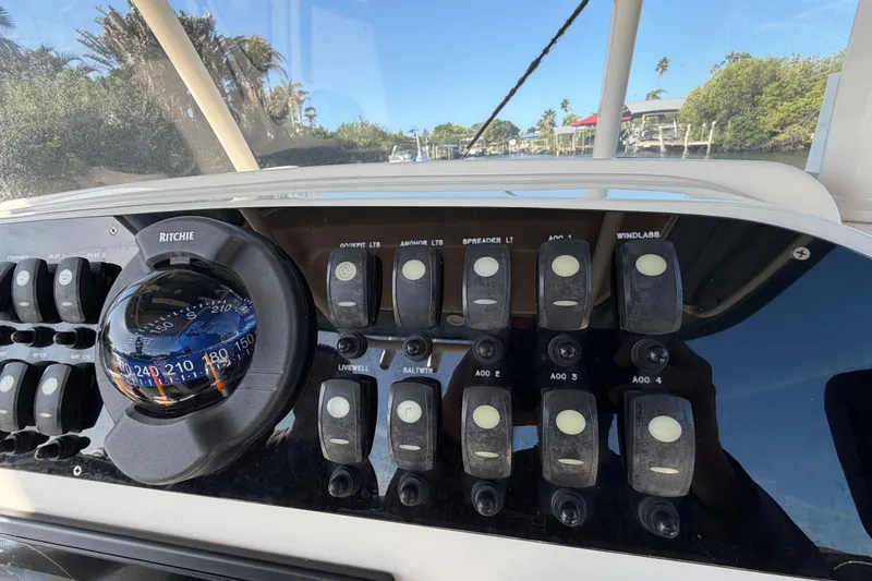 Slide: The Image of Control panel of 2018 Grady-White Canyon 306 boat with compass and switches. - 32