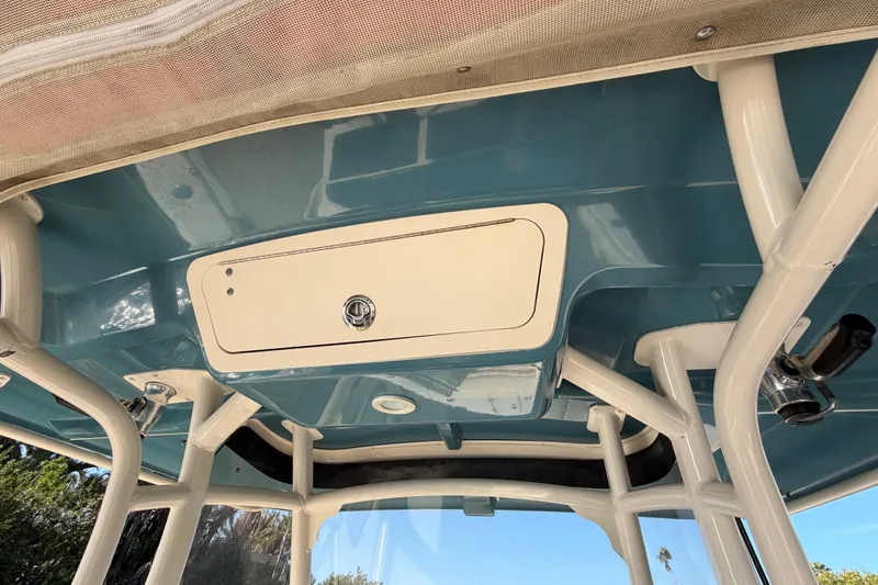 Slide: The Image of 2018 Grady-White Canyon 306 boat interior with storage compartment and rod holders. - 34
