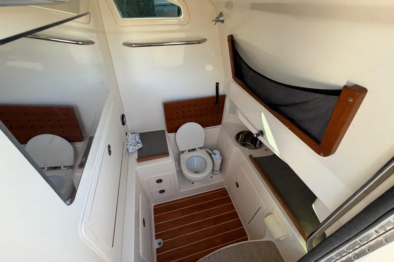 Slide: The Image of 2018 Grady-White Canyon 306 boat interior with toilet and sink. - 35