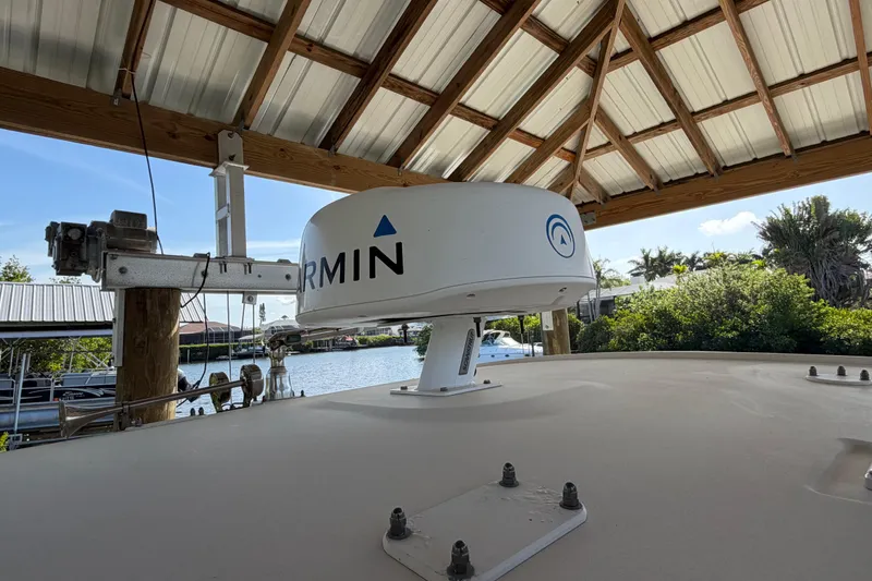 Slide: The Image of 2018 Grady-White Canyon 306 with Garmin radar under a wooden dock roof. - 36