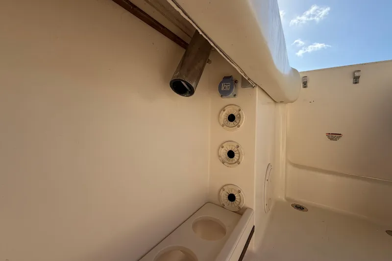 Slide: The Image of 2018 Grady-White Canyon 306 boat interior with rod holders and cup holders. - 38
