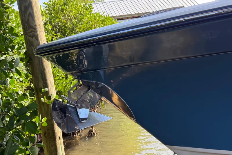 Slide: The Image of 2018 Grady-White Canyon 306 boat bow with anchor, docked near greenery. - 41