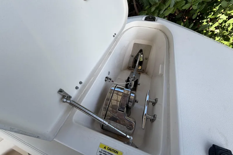 Slide: The Image of Anchor compartment of 2018 Grady-White Canyon 306 boat, featuring stainless steel hardware. - 42