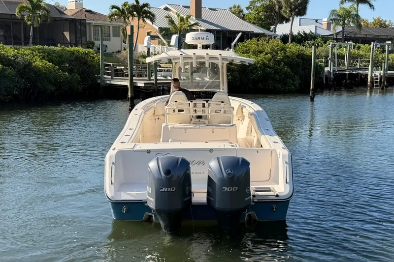 Slide: The Image of 2018 Grady-White Canyon 306 boat with dual Yamaha engines on calm water. - 6