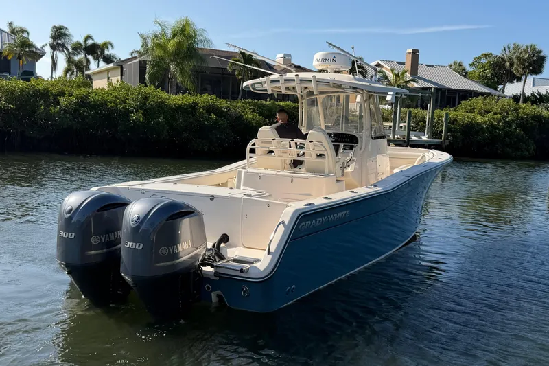Slide: The Image of 2018 Grady-White Canyon 306 boat with twin Yamaha engines on a sunny waterway. - 7