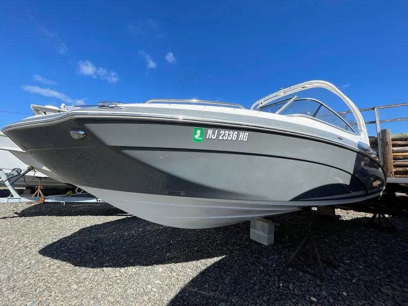 Slide: The Image of 2015 Yamaha Boats 242 Limited S parked on gravel surface. - 2