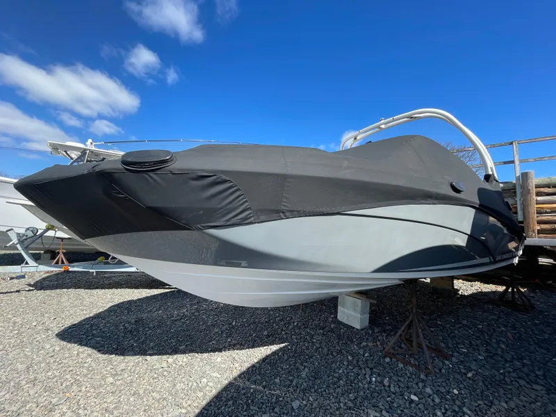Slide: The Image of 2015 Yamaha 242 Limited S boat with cover on gravel. - 23