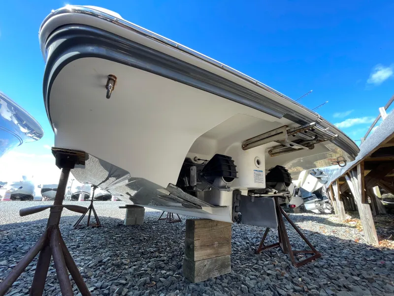 Slide: The Image of 2015 Yamaha Boats 242 Limited S on stands over gravel. - 5