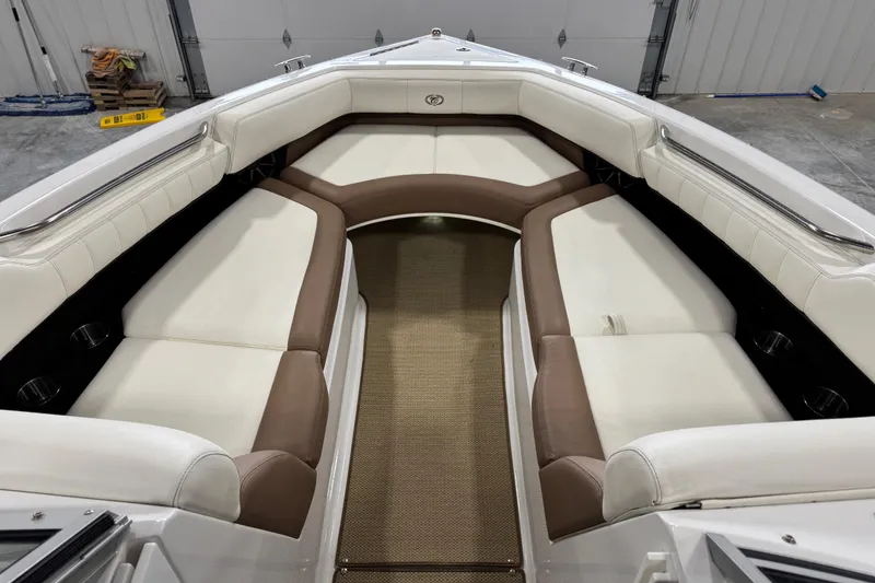 Slide: The Image of Interior of a 2014 Cobalt 276 boat with white and brown seating. - 15