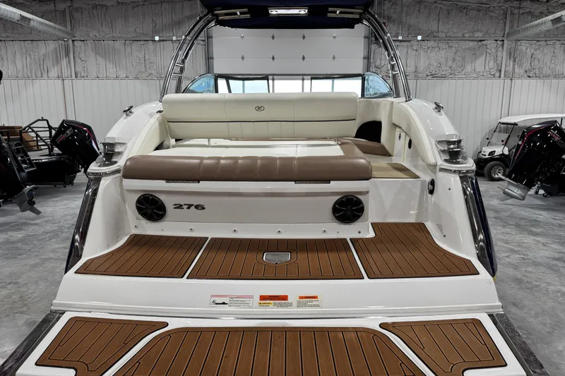 Slide: The Image of 2014 Cobalt 276 boat interior with teak flooring and cushioned seating. - 5