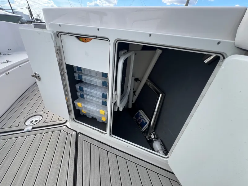 Slide: The Image of Storage compartment in Yamaha 255 FSH Sport E boat, 2023 model. - 13