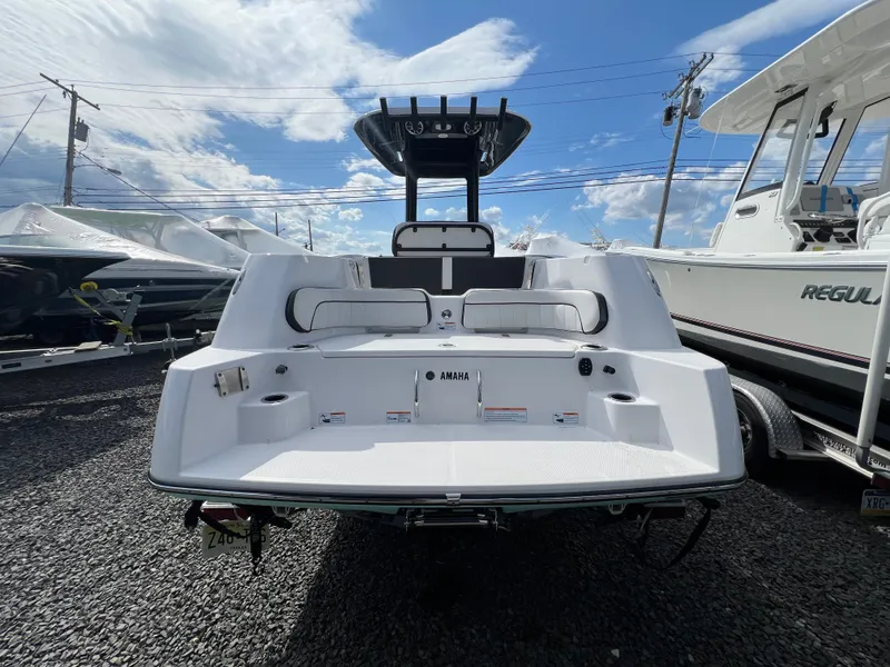 Slide: The Image of Rear view of 2023 Yamaha Boats 255 FSH Sport E on gravel lot. - 2