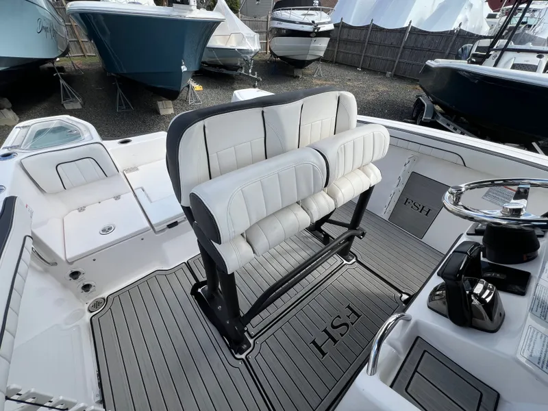 Slide: The Image of Interior of a 2023 Yamaha Boats 255 FSH Sport E with white seating. - 21