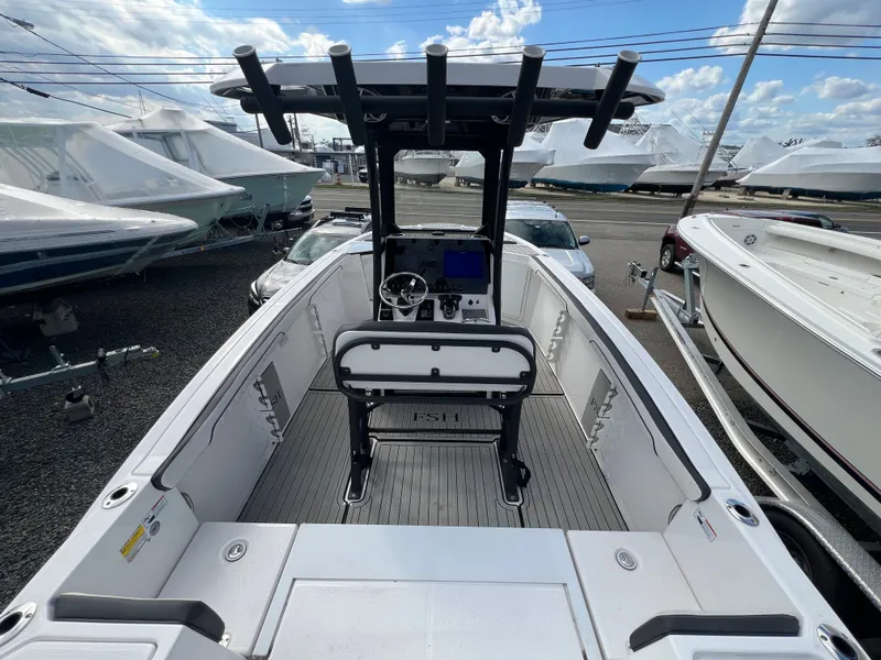 Slide: The Image of Yamaha Boats 2023 model 255 FSH Sport E on a parking lot. - 30